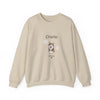 A beige crewneck sweatshirt featuring a custom graphic of a Husky dog with the name 'Charlie' and paw prints on the front, displayed against a solid white background.
